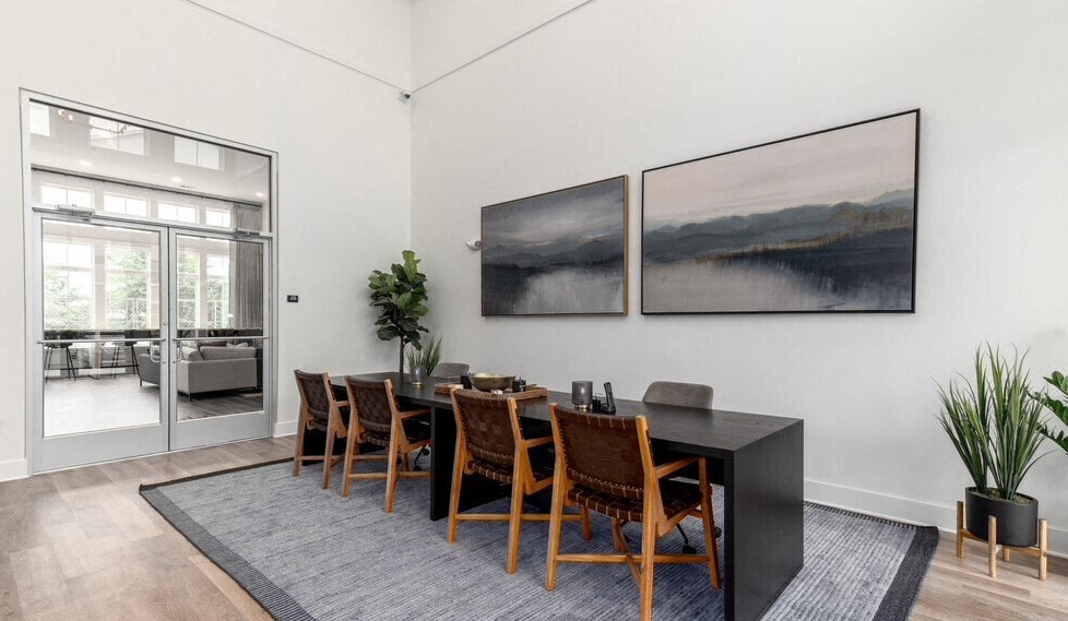 a dining room with a black table and chairs