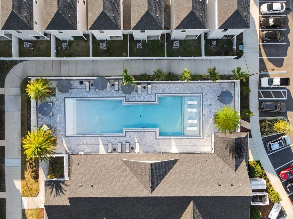 An aerial view of a swimming pool surrounded by a concrete wall.