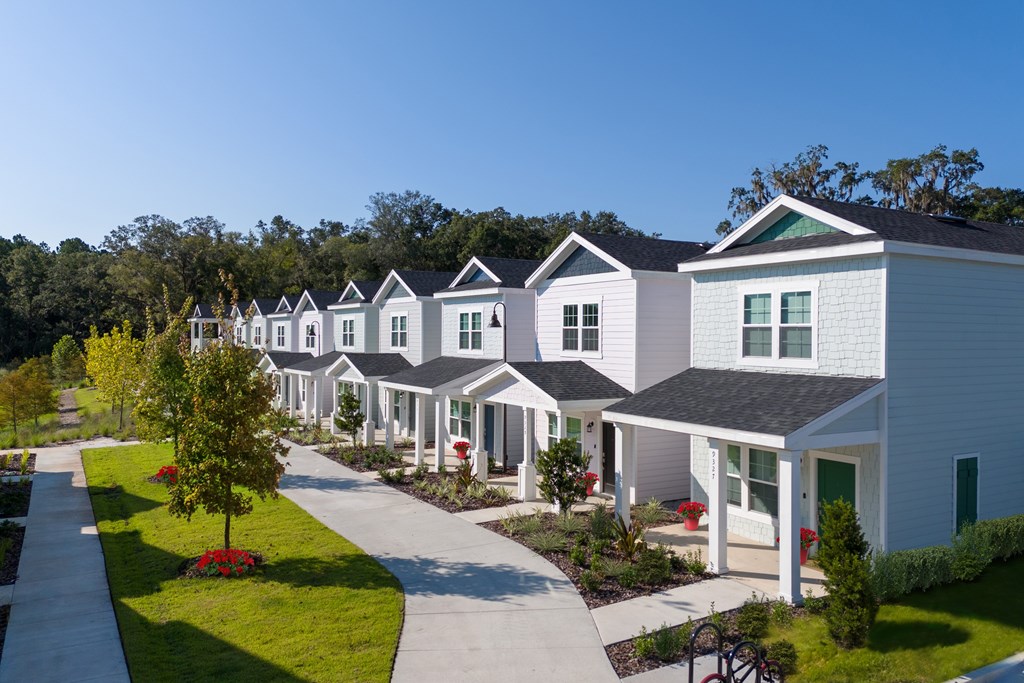 A row of houses with a clear blue sky above them.