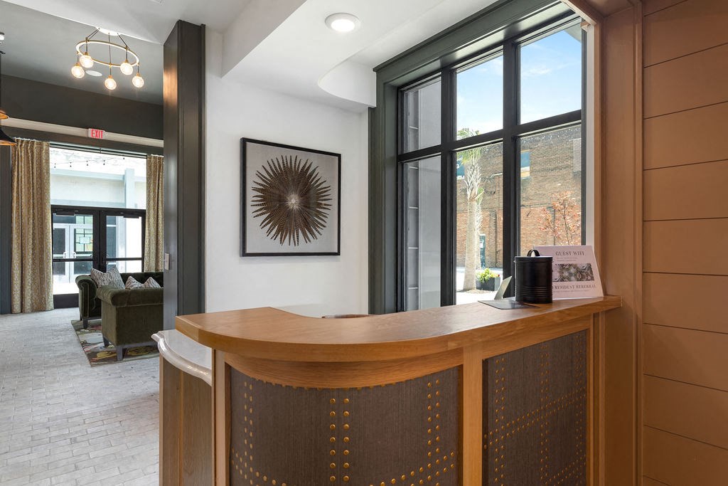 a reception desk in a hotel lobby with a large window