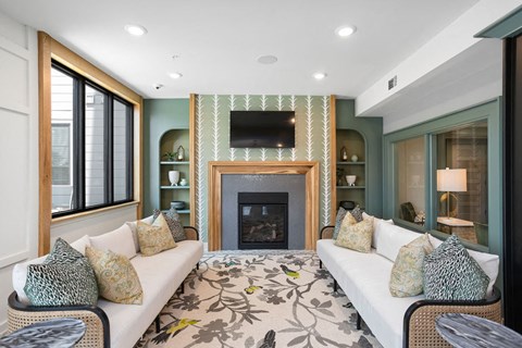 a living room with a white couch and a fireplace