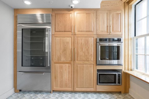 a kitchen with wooden cabinets and stainless steel appliances