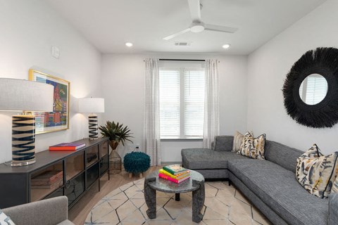 a living room with a gray couch and a coffee table