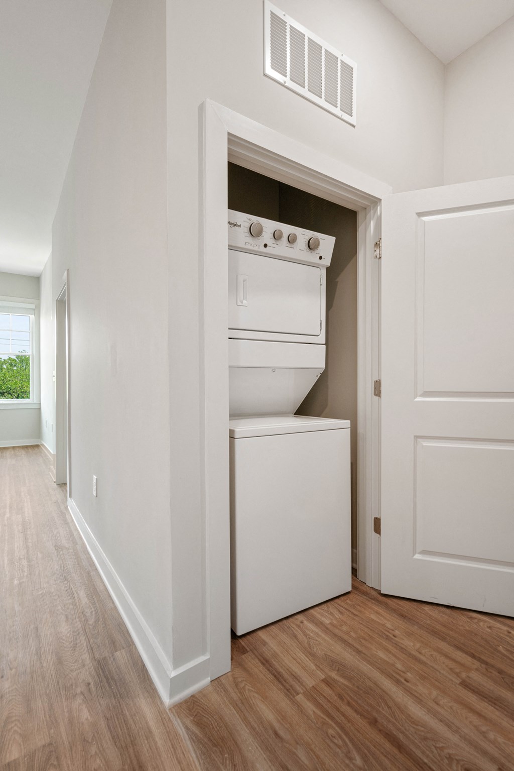an empty room with a washer and dryer in a closet