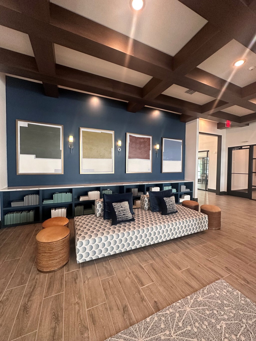 a lobby with blue walls and a couch and tables
