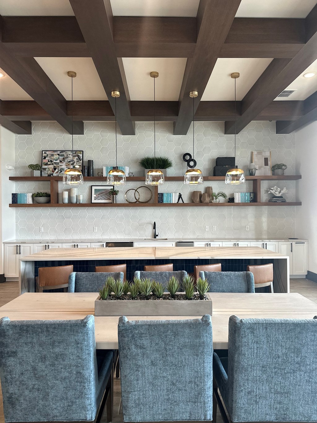 a dining room with a table and chairs and a kitchen