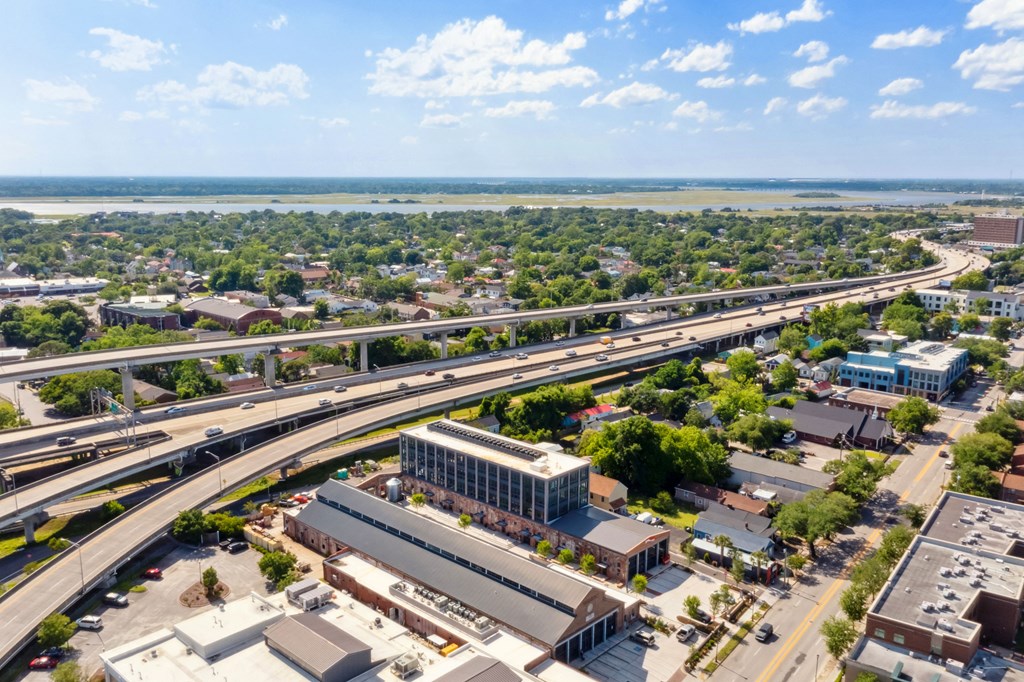 an aerial view of a city with highways and buildings