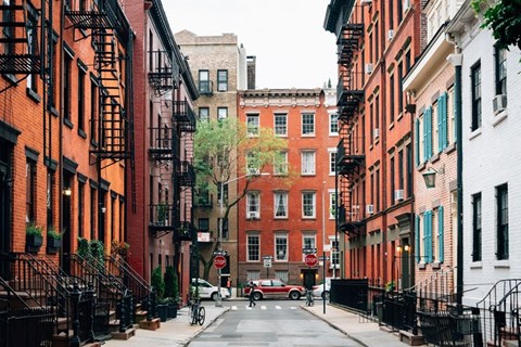 A red car is parked on the street.