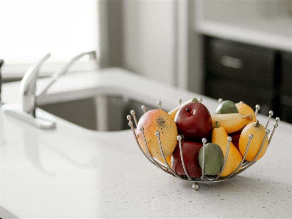 a bowl of fruit sitting on a kitchen counter