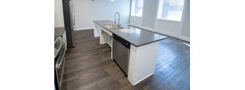 a kitchen with a counter top and a sink