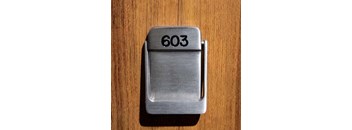 a metal object with the number 603 on a wooden table