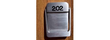 a silver plate with the number 2022 on a wooden table