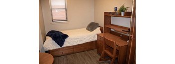 a bedroom with a bed and a desk