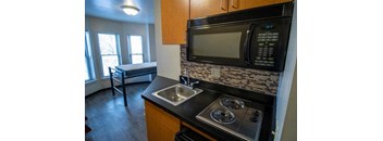 a kitchen with a stove and a microwave and a sink