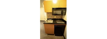 a small kitchen with a microwave and a sink