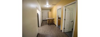 a room with a kitchen and a table