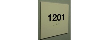 a white sign with numbers on a wall