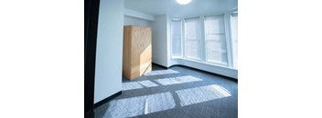 an empty room with a cabinet in the middle of it