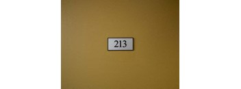 a yellow wall with a number on it