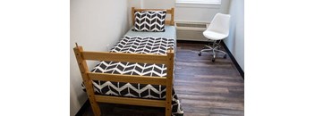 a bedroom with a bunk bed and a chair