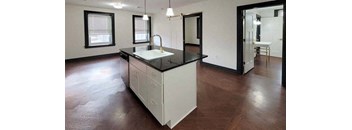 an empty room with a sink and a mirror