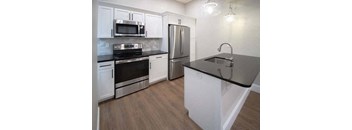a kitchen with stainless steel appliances and white cabinets