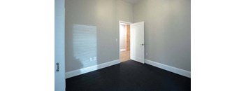 a empty room with a door and a window