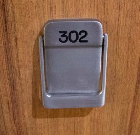 a silver light switch on a wooden table