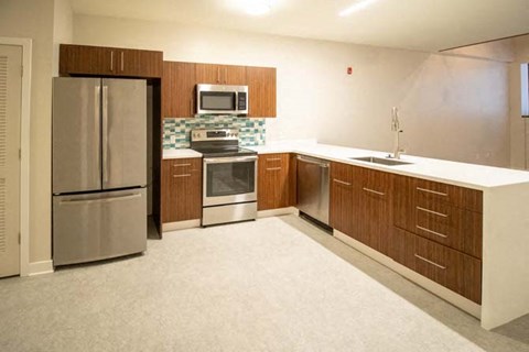 a kitchen with stainless steel appliances and wooden cabinets