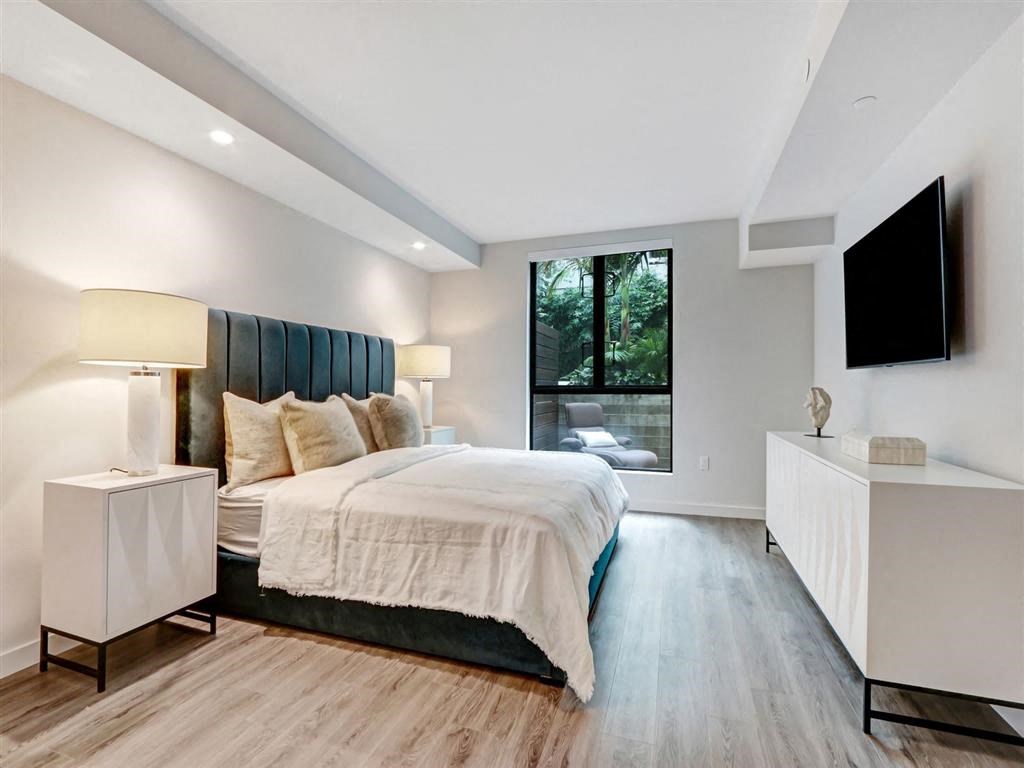 a bedroom with a bed and a tv