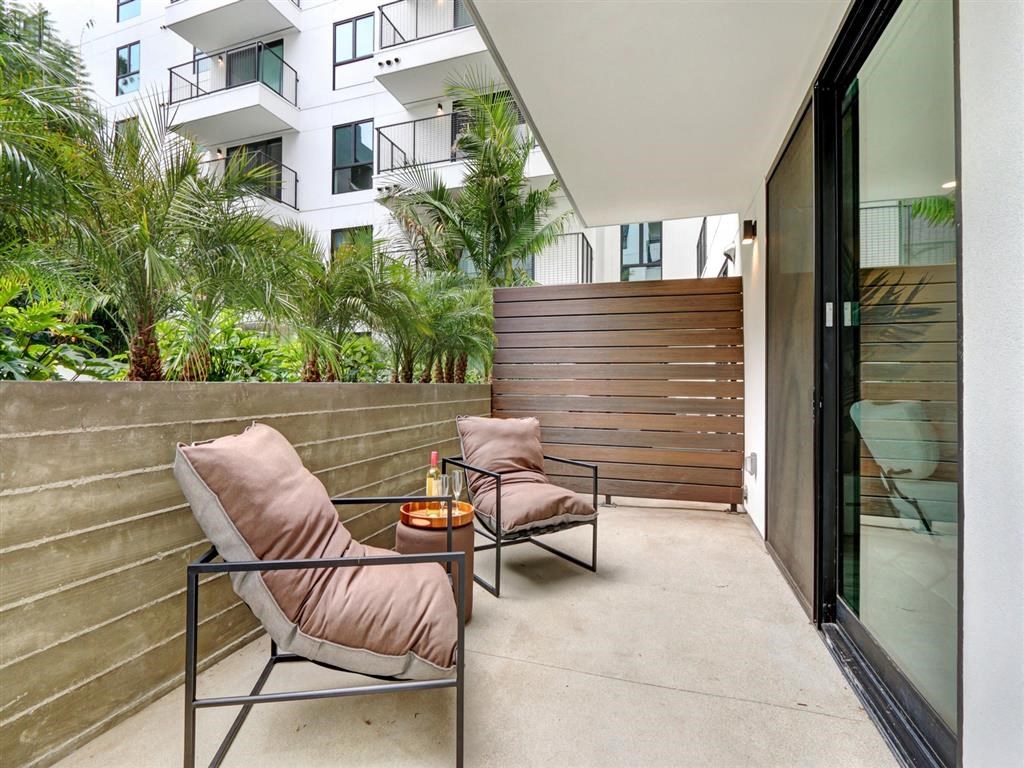 a balcony or terrace with two chairs and a table