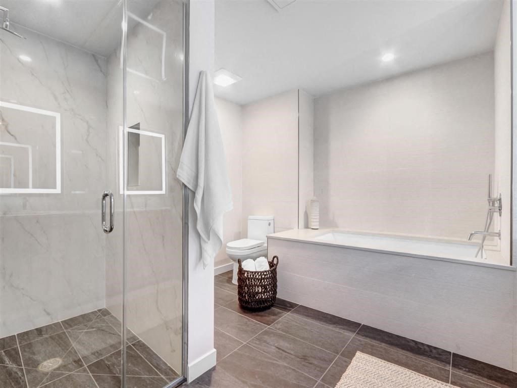 a white bathroom with a shower and a tub