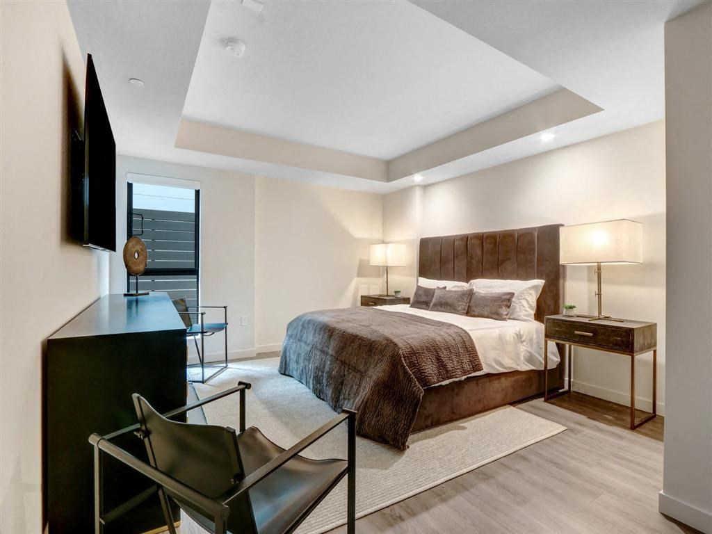 a bedroom with a bed and a tv