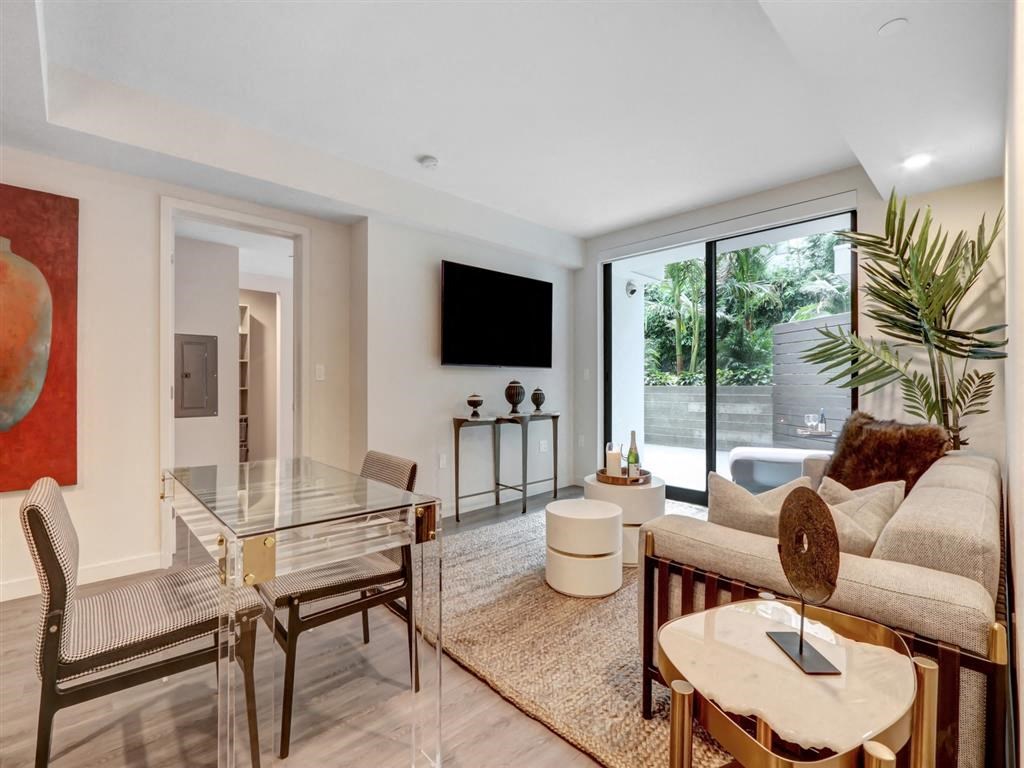 a living room with a glass table and a couch