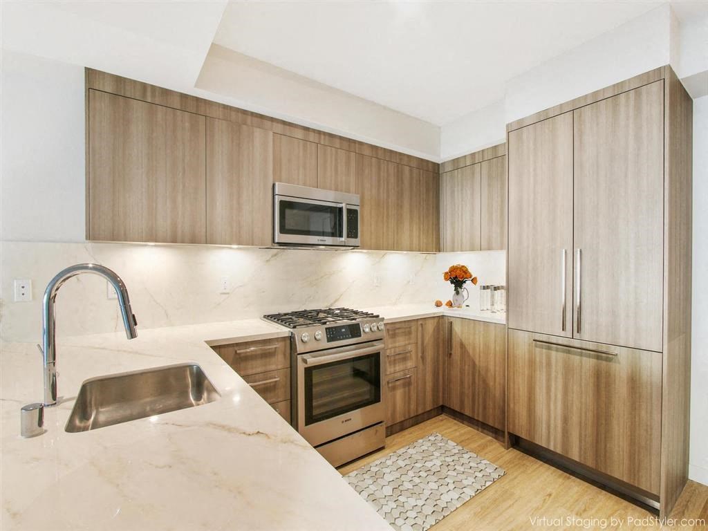 a kitchen with wooden cabinets and a sink