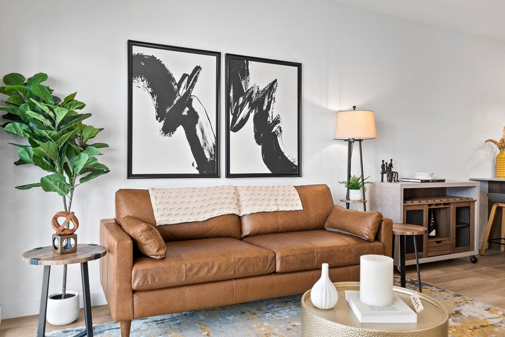 a living room with a couch and two paintings on the wall