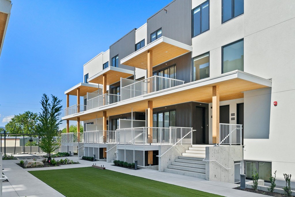 a modern home with a lawn in front of it