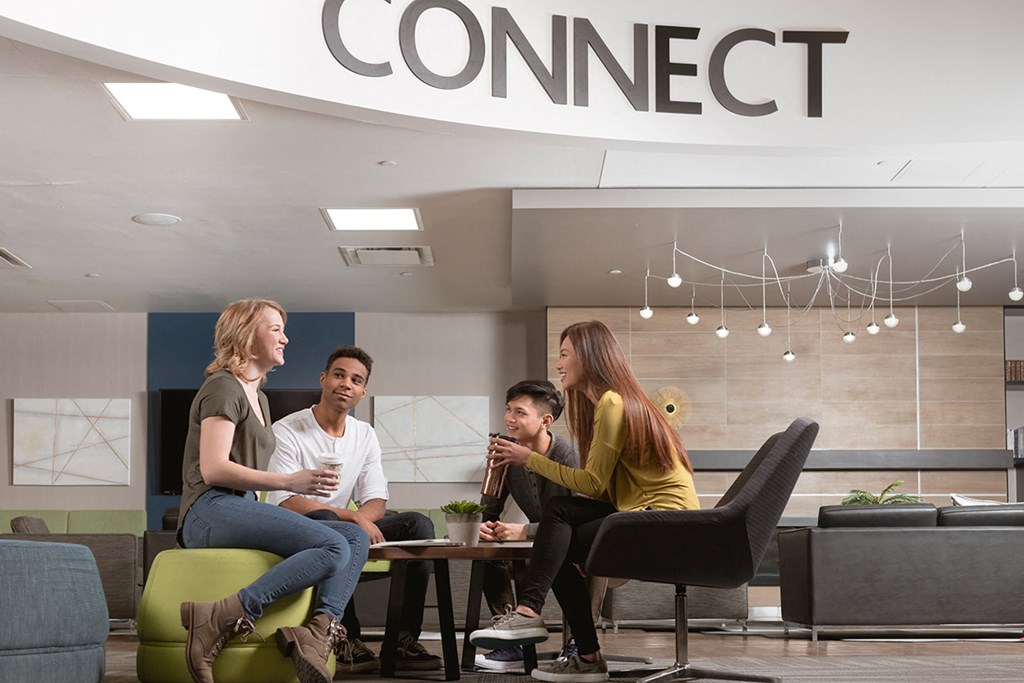 a group of people sitting around a table in a lobby