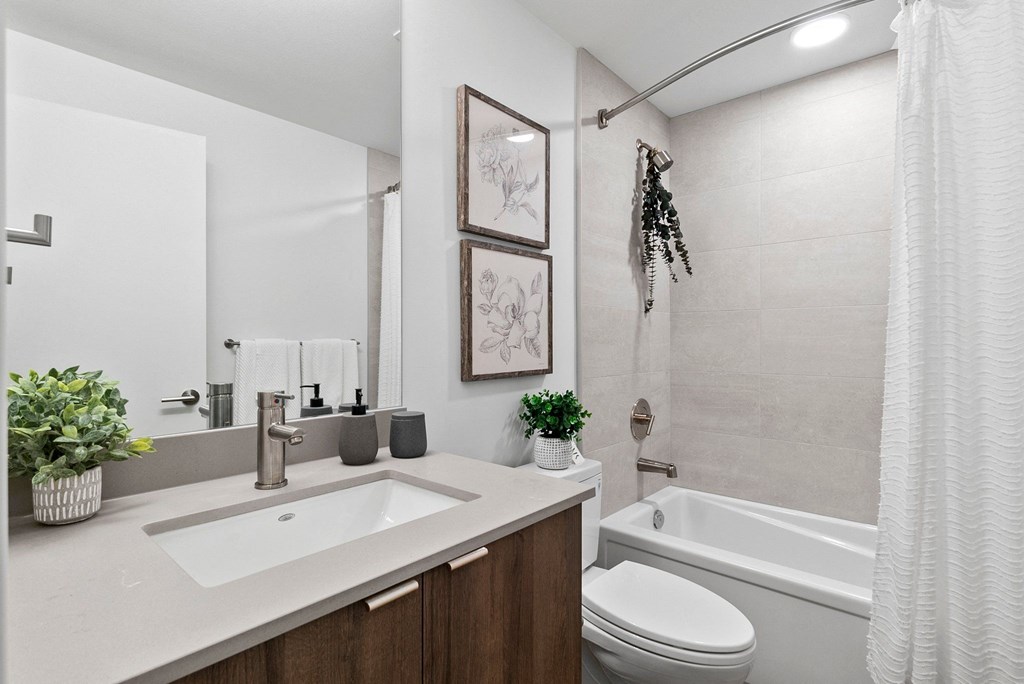a bathroom with a toilet sink and bathtub in a 555 waverly unit