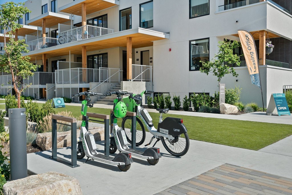 a couple of bikes parked in front of a building