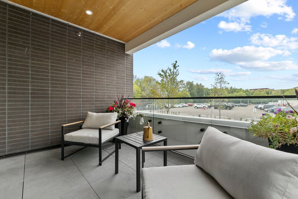 a balcony with two chairs and a table