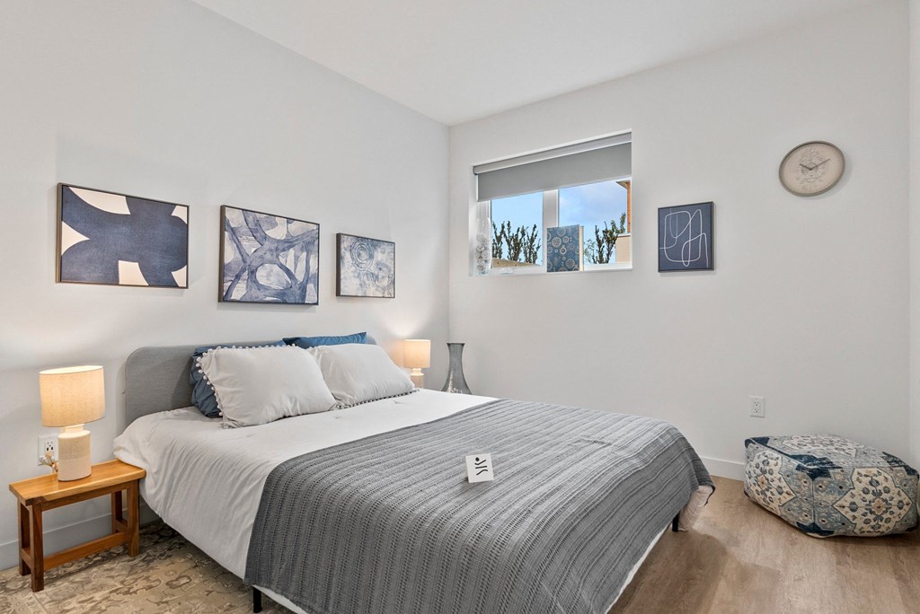 a bedroom with a bed and a window