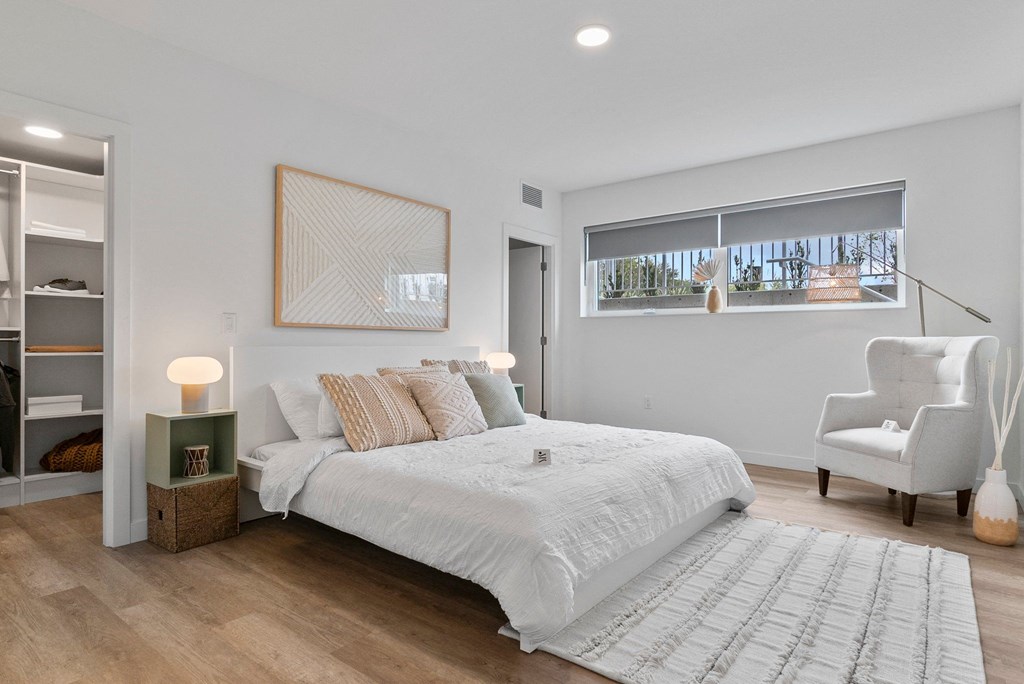 a bedroom with a bed and a chair