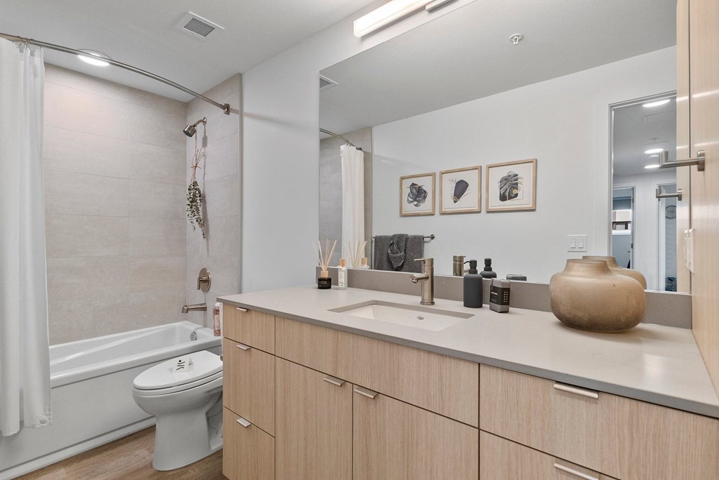 a bathroom with a toilet sink and bathtub in a 555 waverly unit