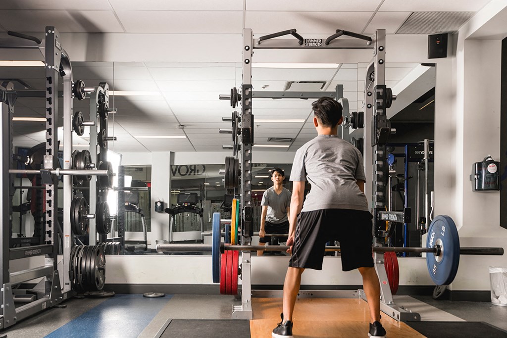 a man lifting weights in a gym