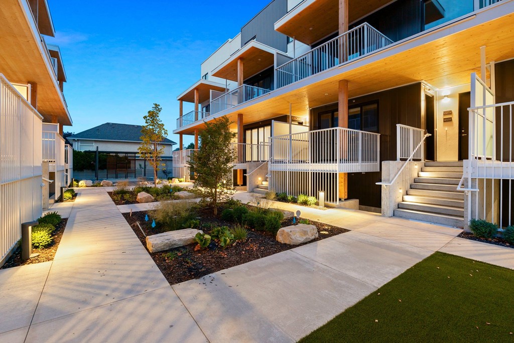 a courtyard is lit up at night