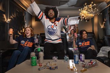 a man in a cubs jersey celebrates with friends in a living room