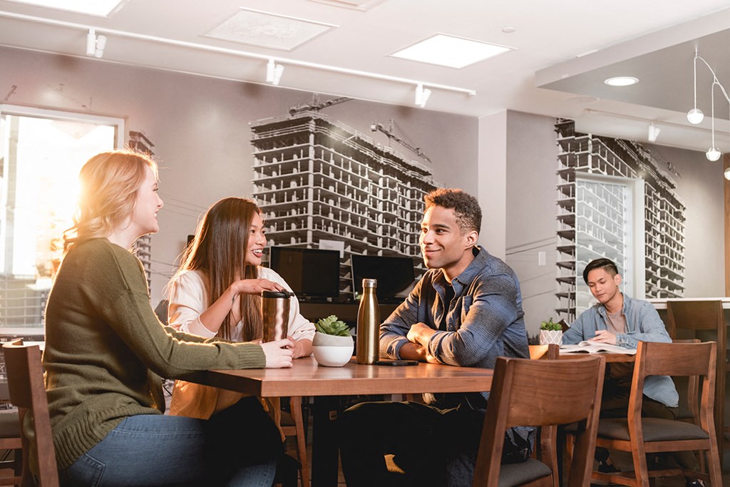 a group of people sitting around a table in a restaurant