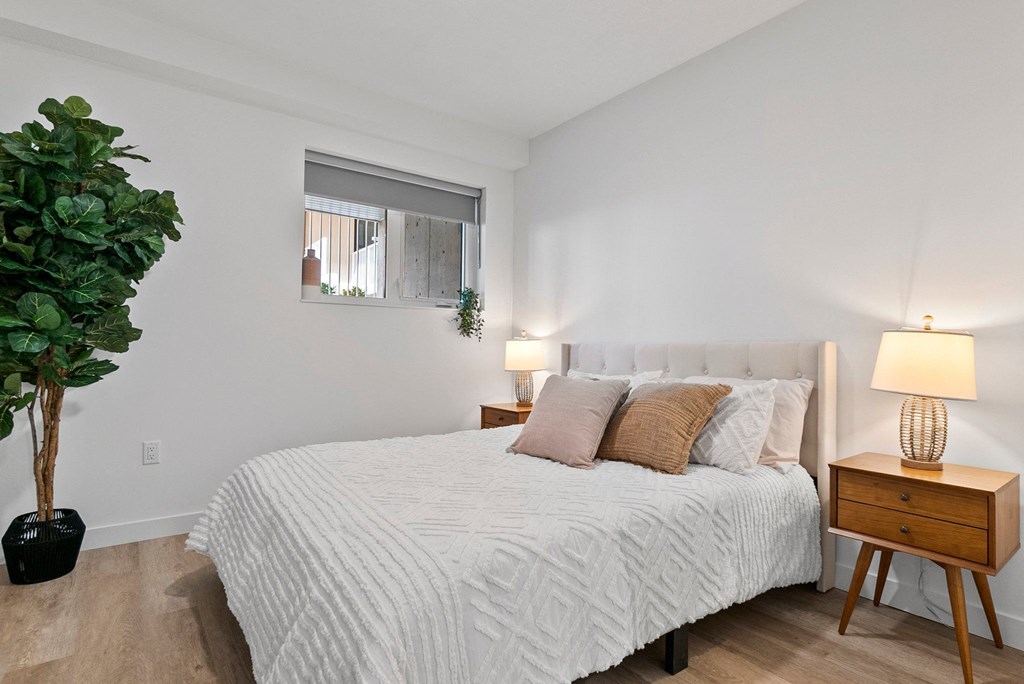 a bedroom with a large bed and a window