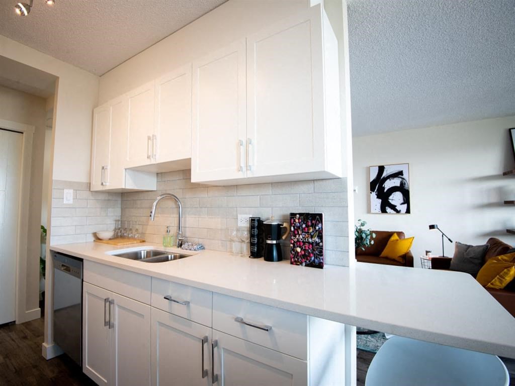 a kitchen with white cabinets and a sink